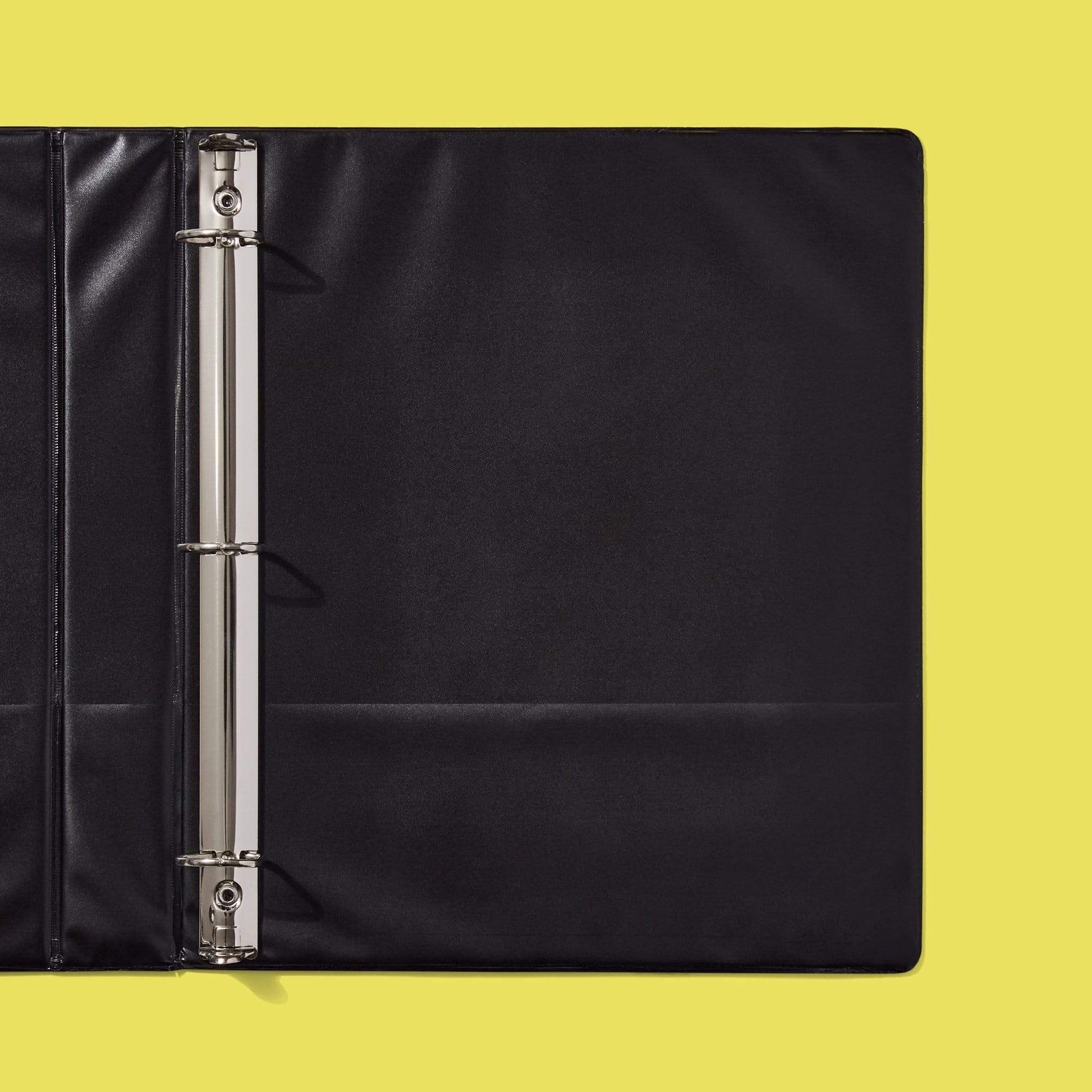 Inside of open 3-ring binder solid black with two inside pockets