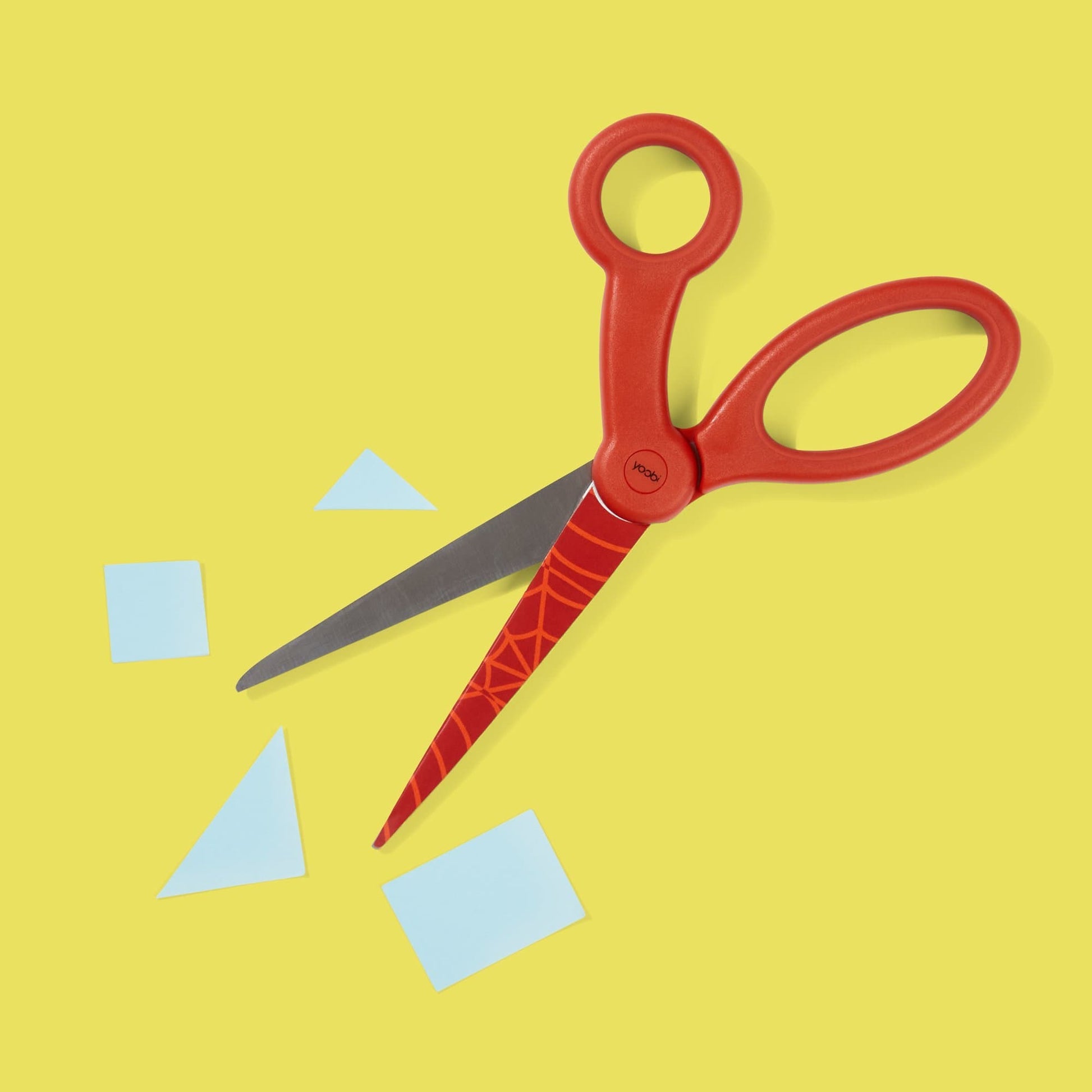 red scissors with red Spider-Man web design on top blade